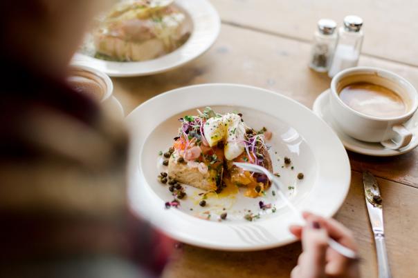 Person Eating Food In White Plate